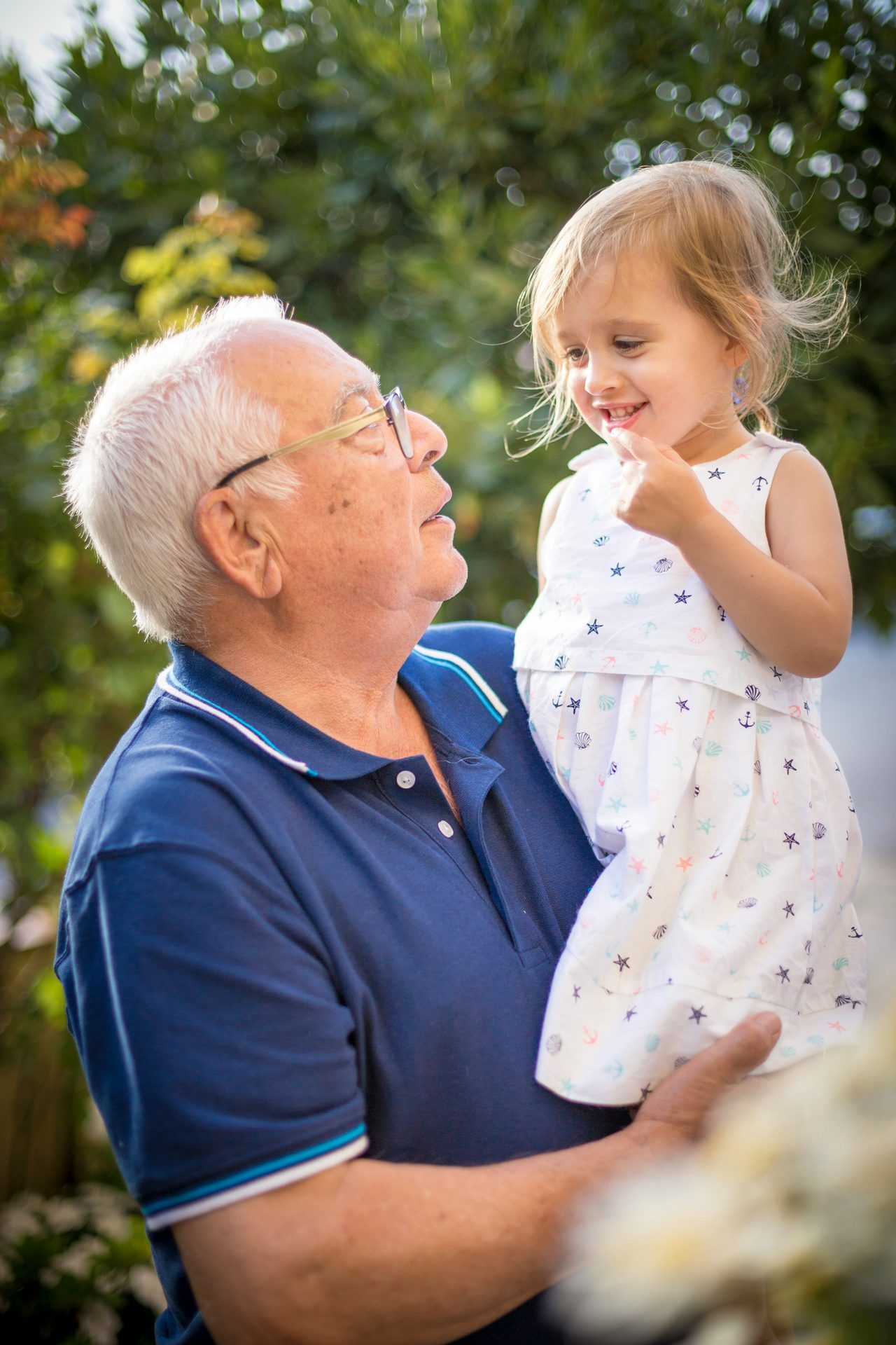 Grandfather smiling with granddaughter